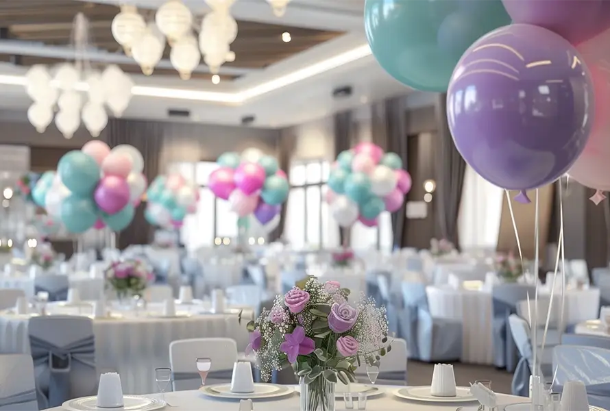 A beautifully decorated banquet hall featuring pastel balloon clusters and elegant floral centerpieces, turning every birthday into magic memories with event management in Iritty.